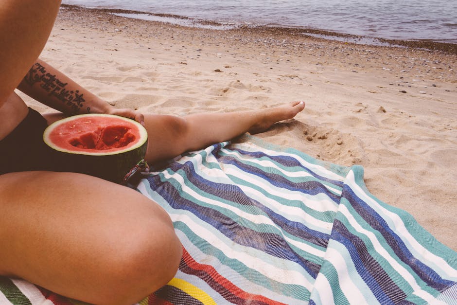 Enjoying a sunny day at the beach with watermelon and relaxation.